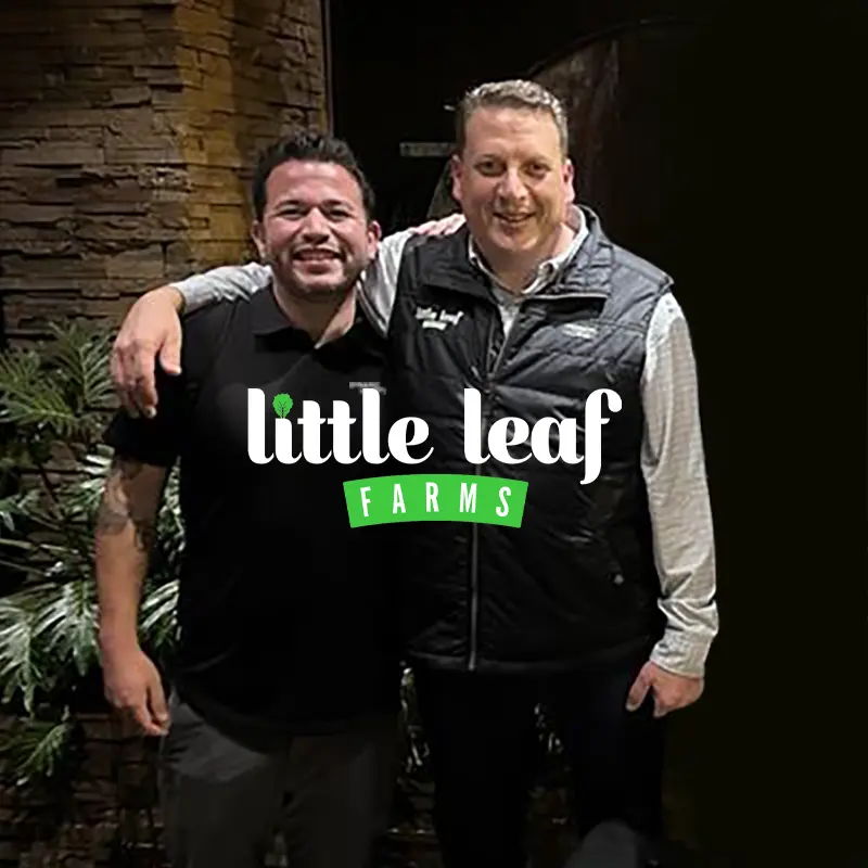 Two smiling individuals stand side by side, overlaid with the "little leaf FARMS" logo.