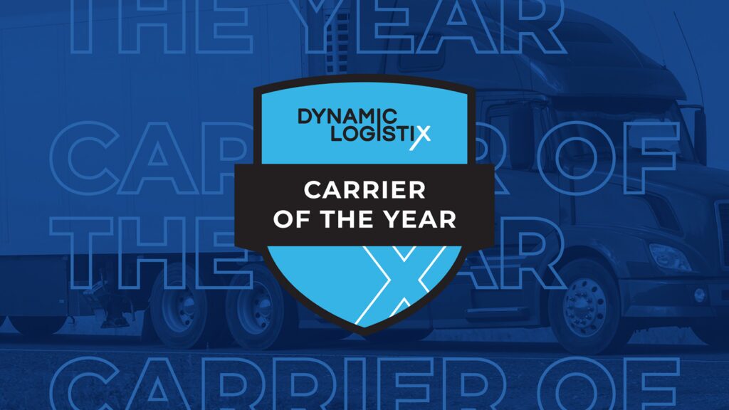 A blue badge reads Dynamic Logistix Carrier of the Year over a dark semi-truck background with the words Carrier of the Year repeated in large text.