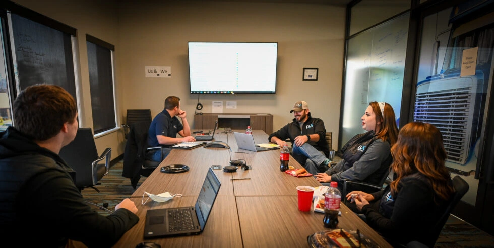 Dynamic Logistix employees meeting in a conference room