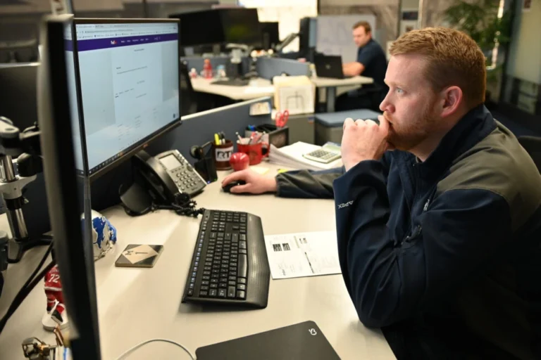 DLX Employee Sitting at Desk